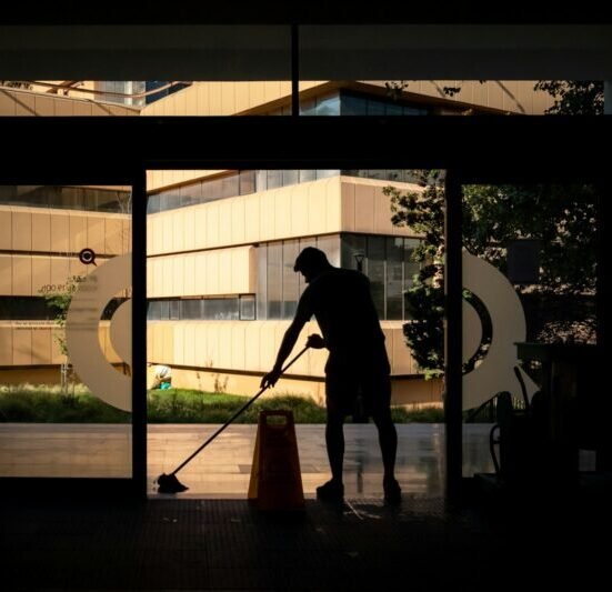 silhouette of man standing near glass window during daytime